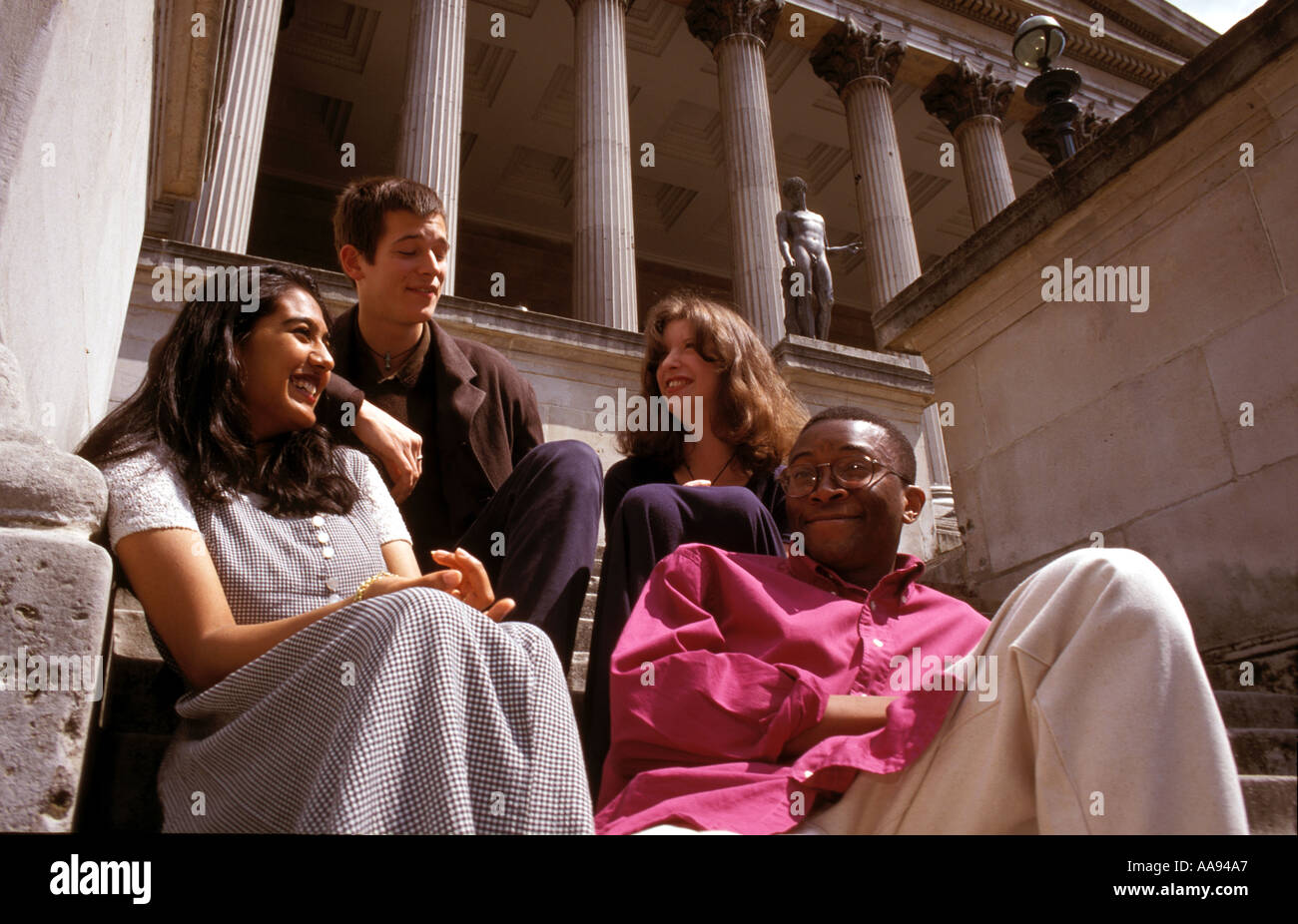 Multiracial student group chatting  on campus. Stock Photo