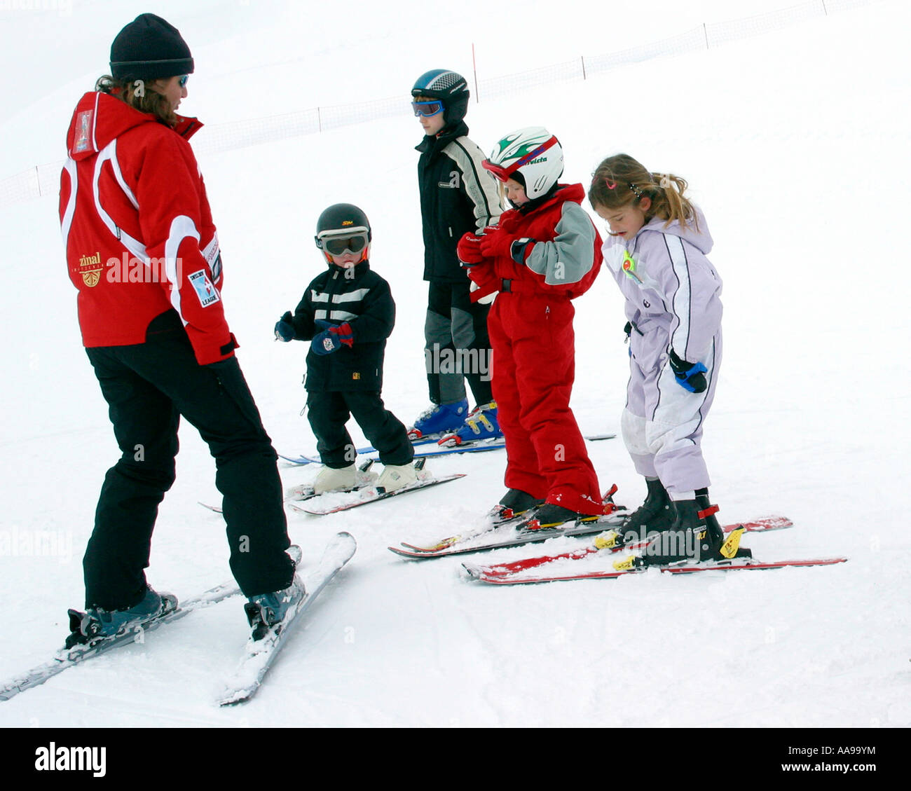 Zinal ski instructress with a group of young kids on short skis about to start their lesson Stock Photo