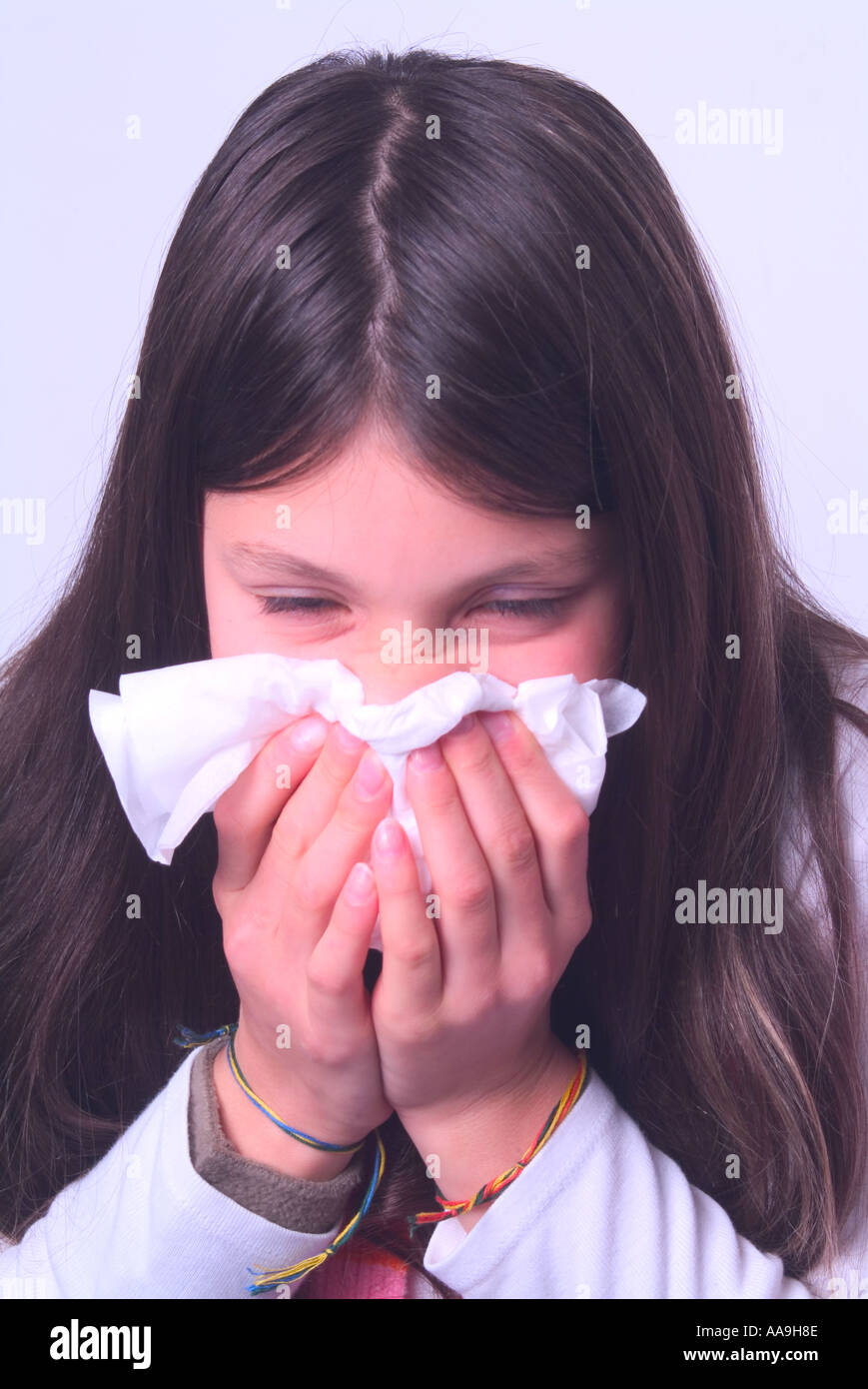 Young girl blowing her nose Stock Photo Alamy