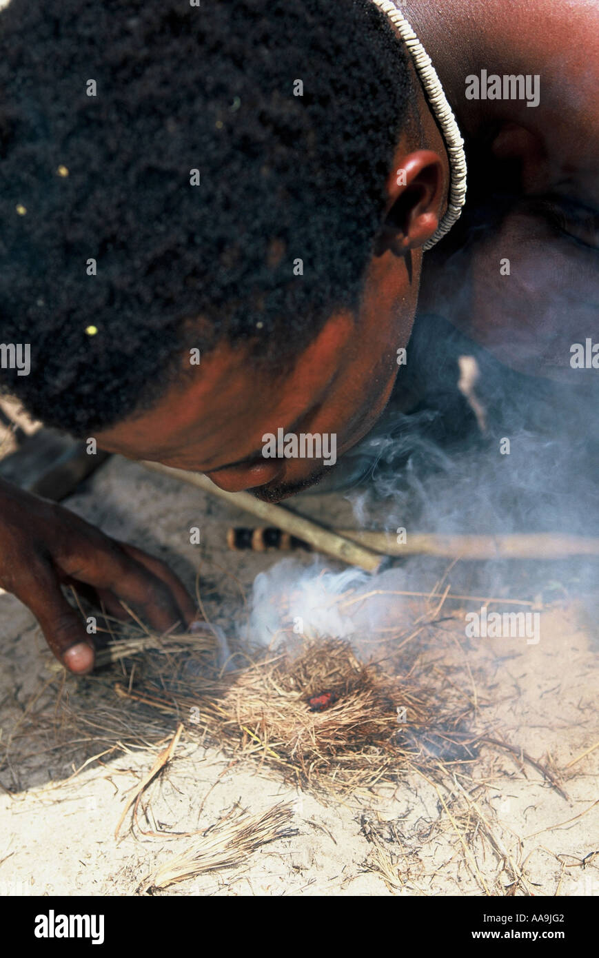 San or Bushman making fire using traditional method Stock Photo - Alamy