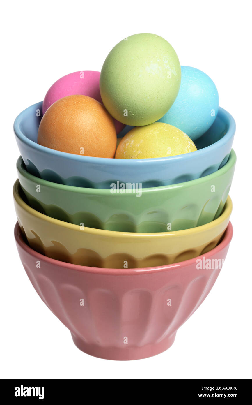 Stack of colored bowls with dyed Easter eggs. Stock Photo