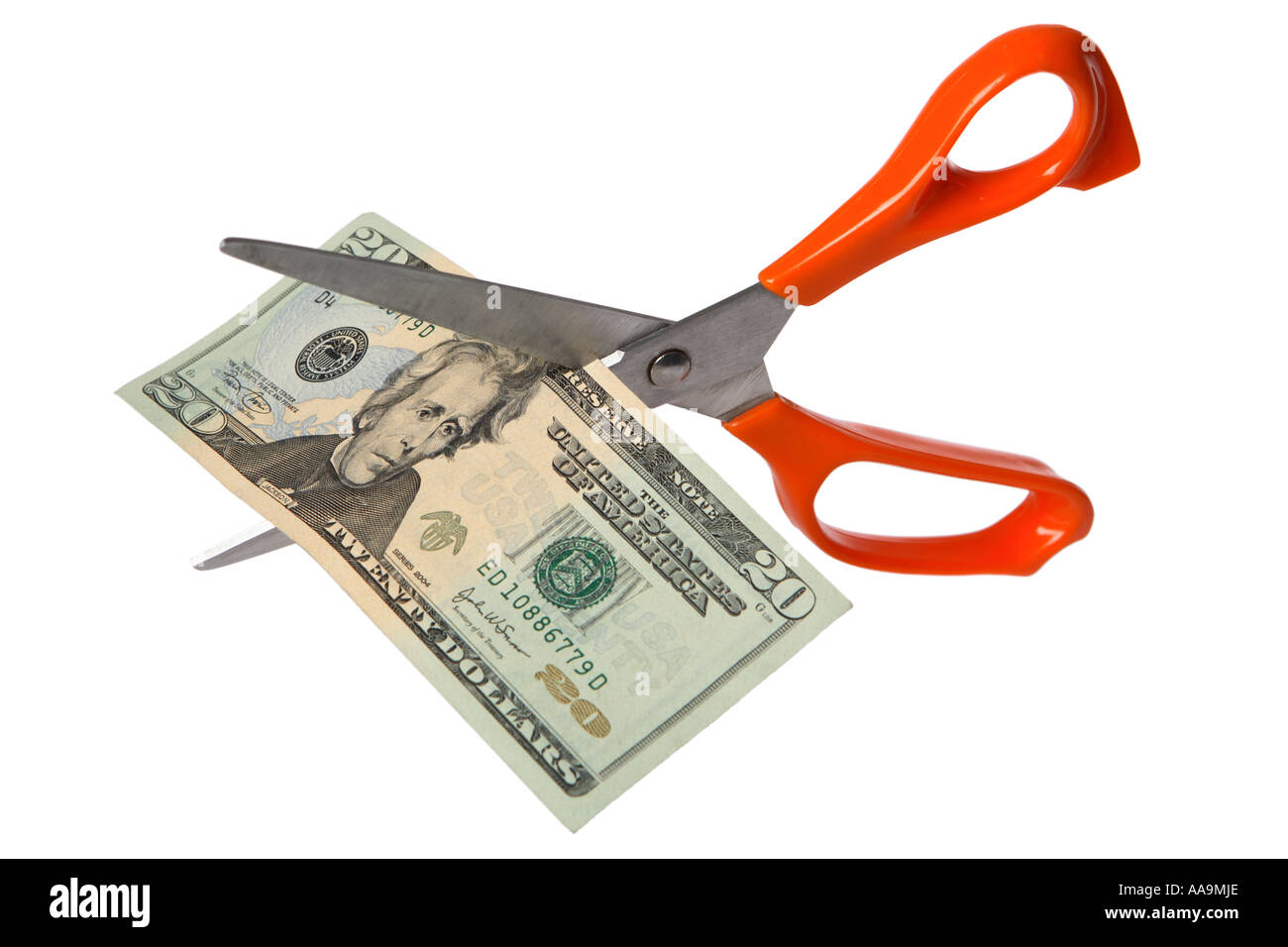 Scissors cutting US twenty dollar bill Stock Photo