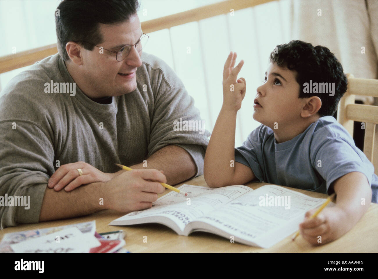Father helping his son with homework Stock Photo - Alamy