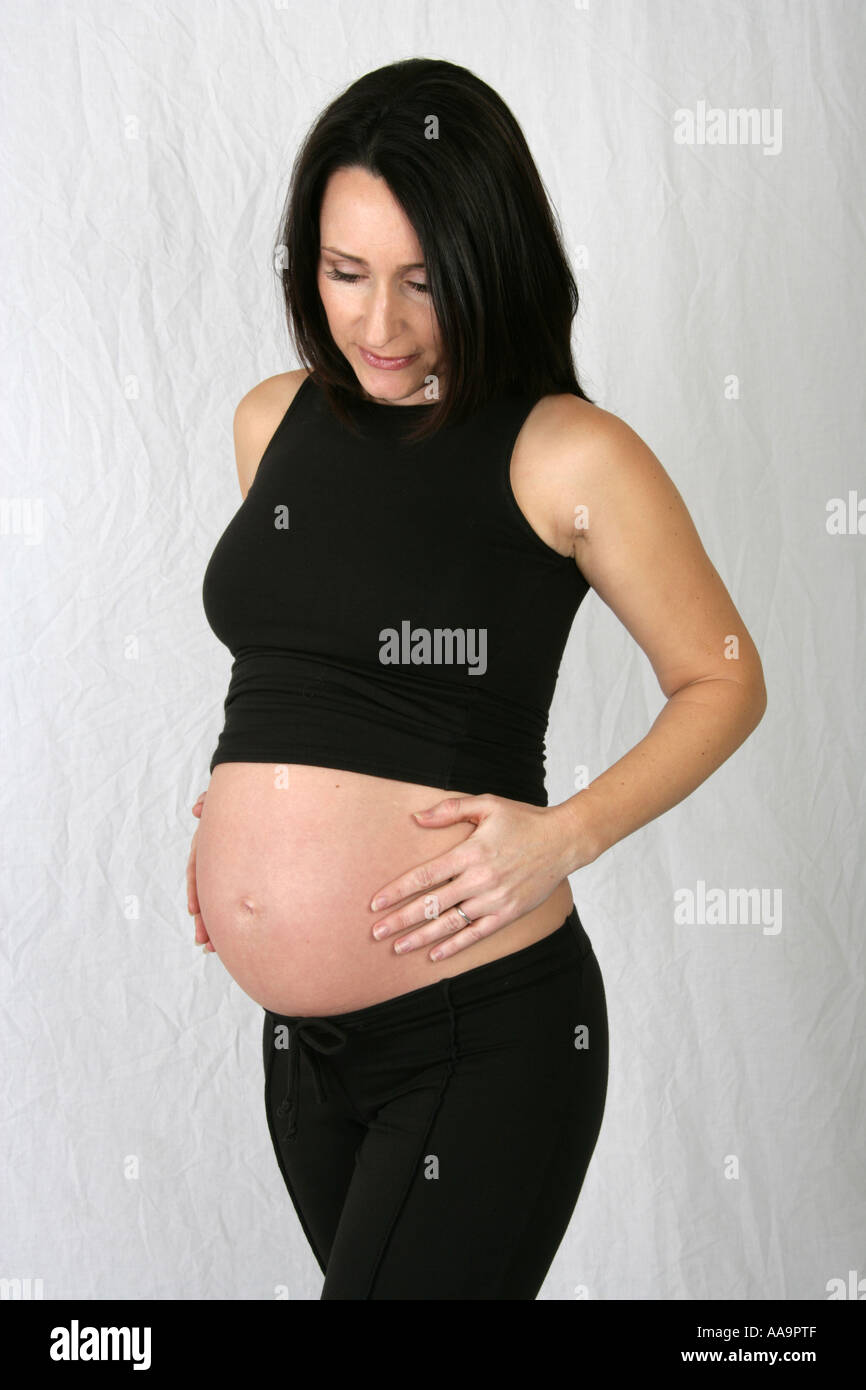 Pregnant Woman Wearing a Black Vest Top and Black Trousers Stock Photo