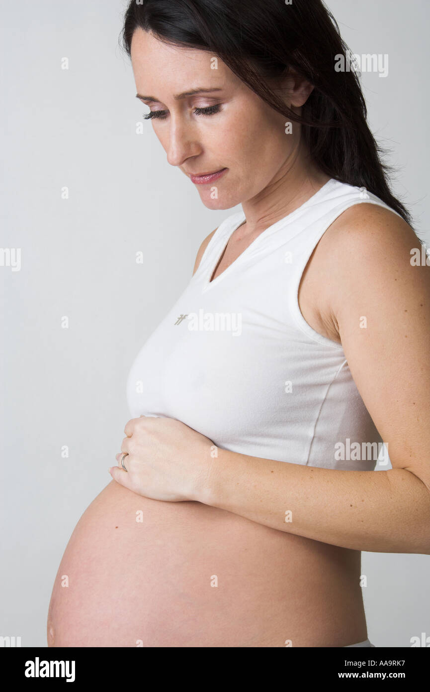 Pregnant Woman Wearing a White Top and Knickers Stock Photo