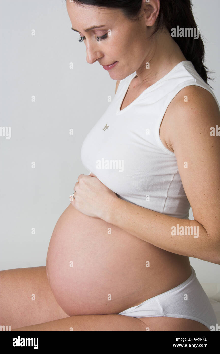 Pregnant Woman Wearing a White Top Stock Photo