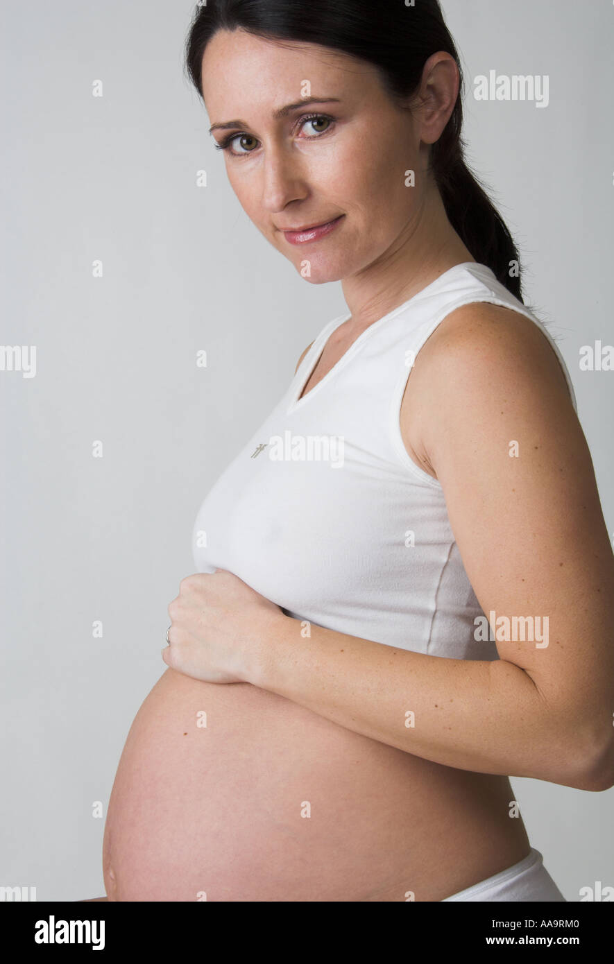 Pregnant Woman Wearing a White Top Stock Photo