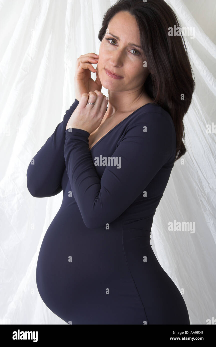 Pregnant Woman in a Blue Dress Stock Photo