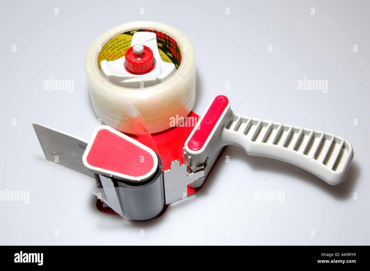 handheld sticky tape dispenser on white background Stock Photo Alamy