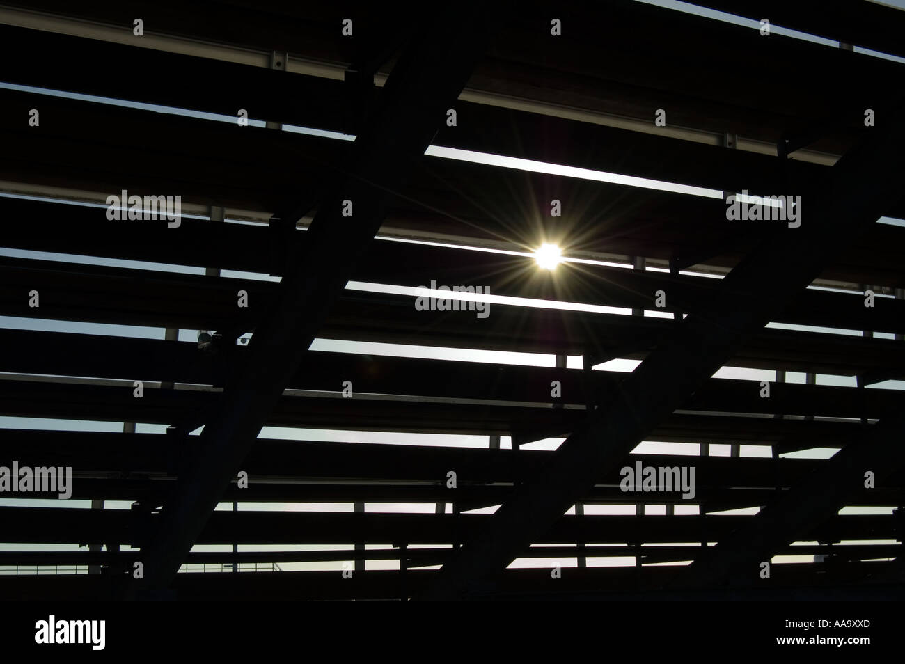 Football bleacher seats with sun peaking through the crack Stock Photo