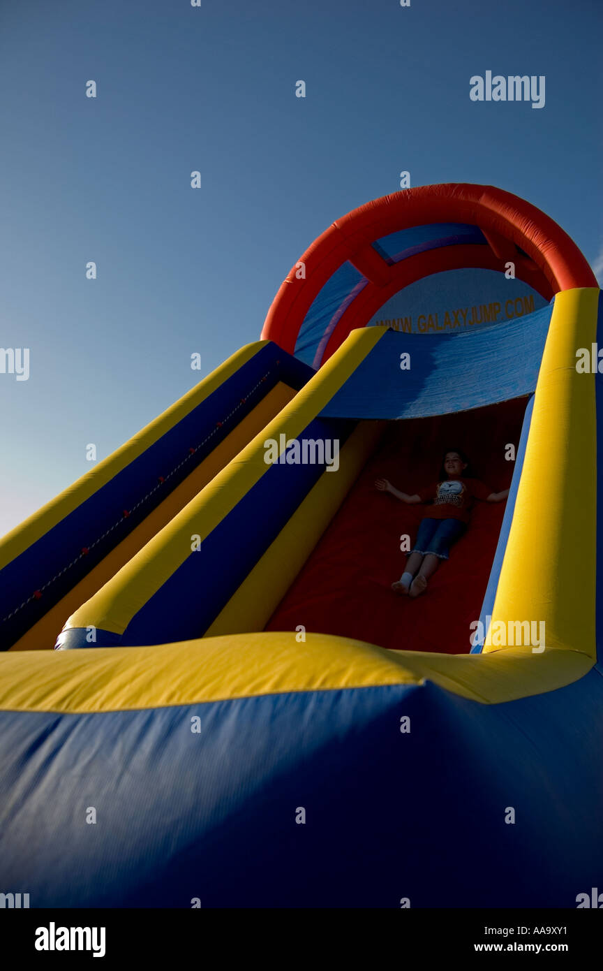 Inflated childrens party moon bouncer slide Stock Photo