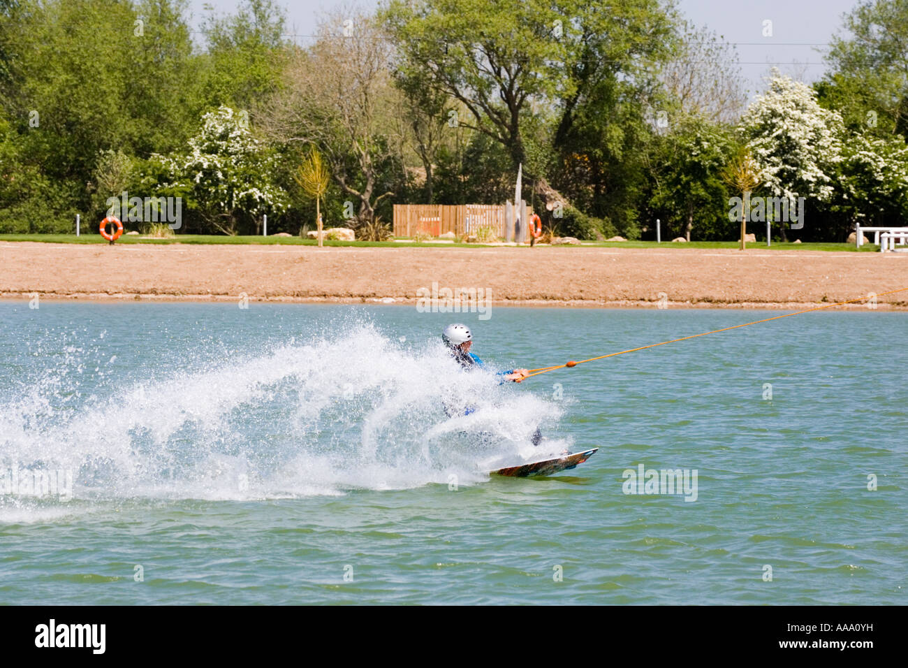 Wake boarding with a cable tow at Watermark Ski, Cotswold Water Park, South Cerney, Gloucestershire Stock Photo