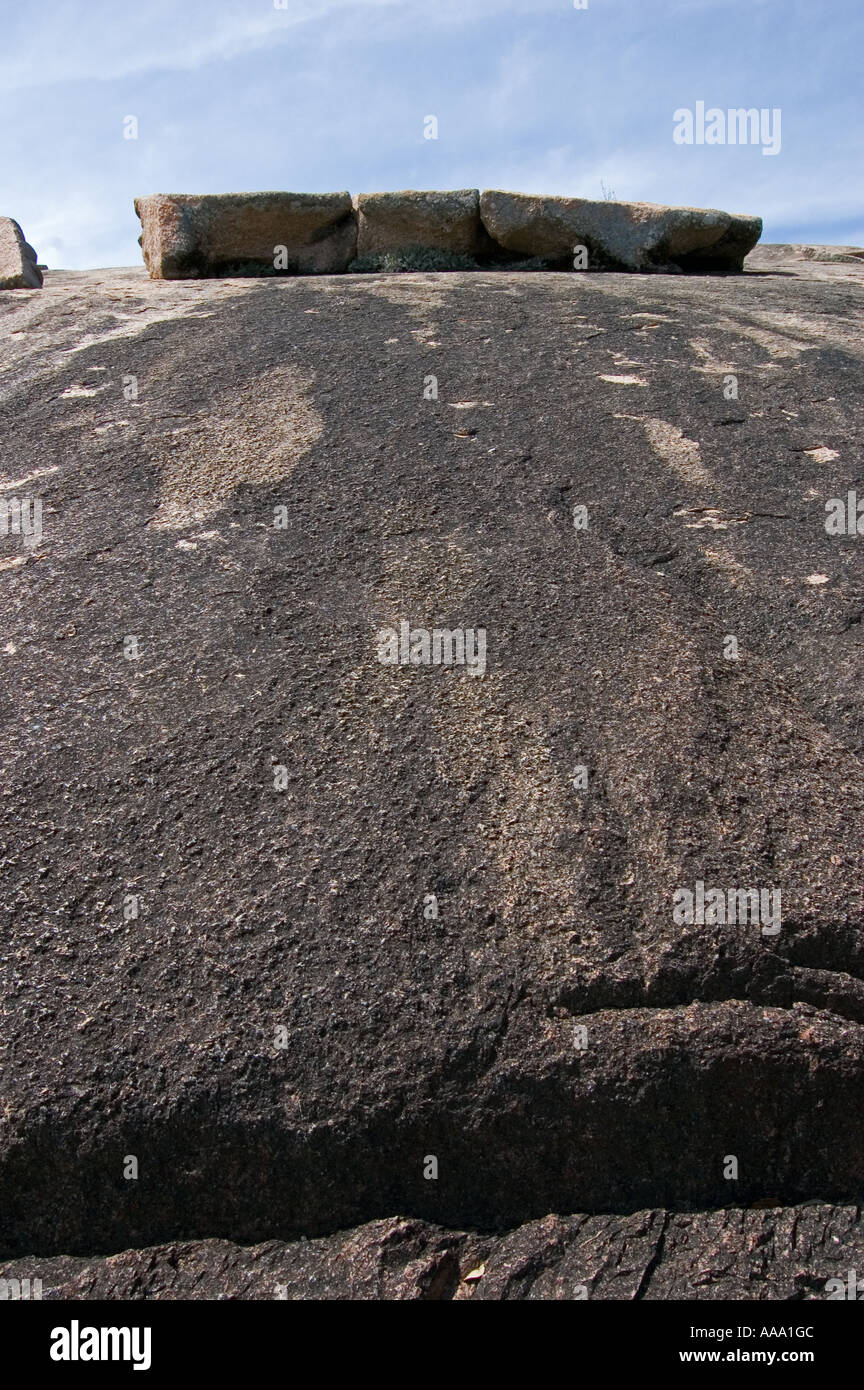 Boulders on top of granite mountain in rugged hill country Stock Photo