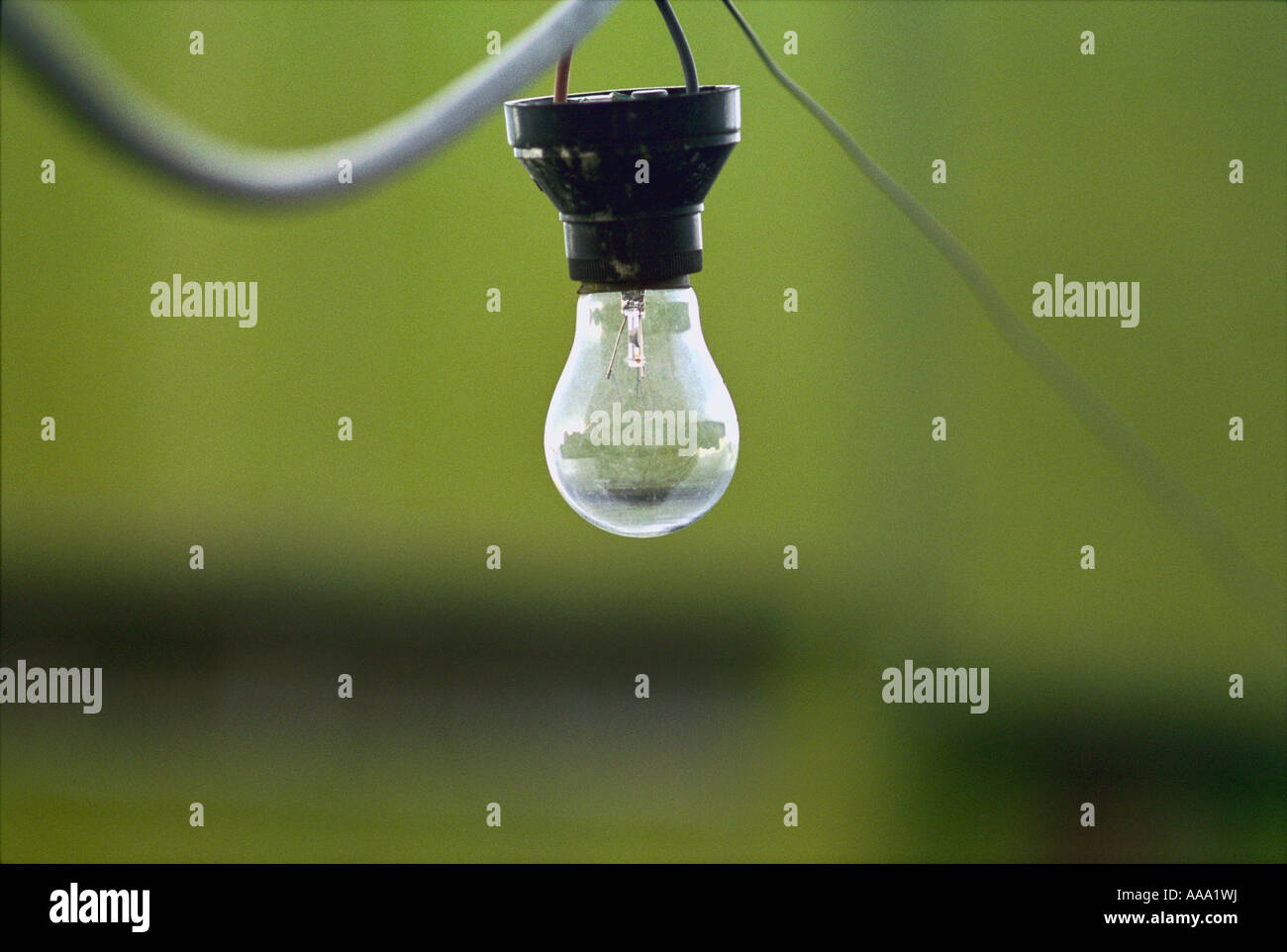 A hanging incandescent lightbulb. Stock Photo
