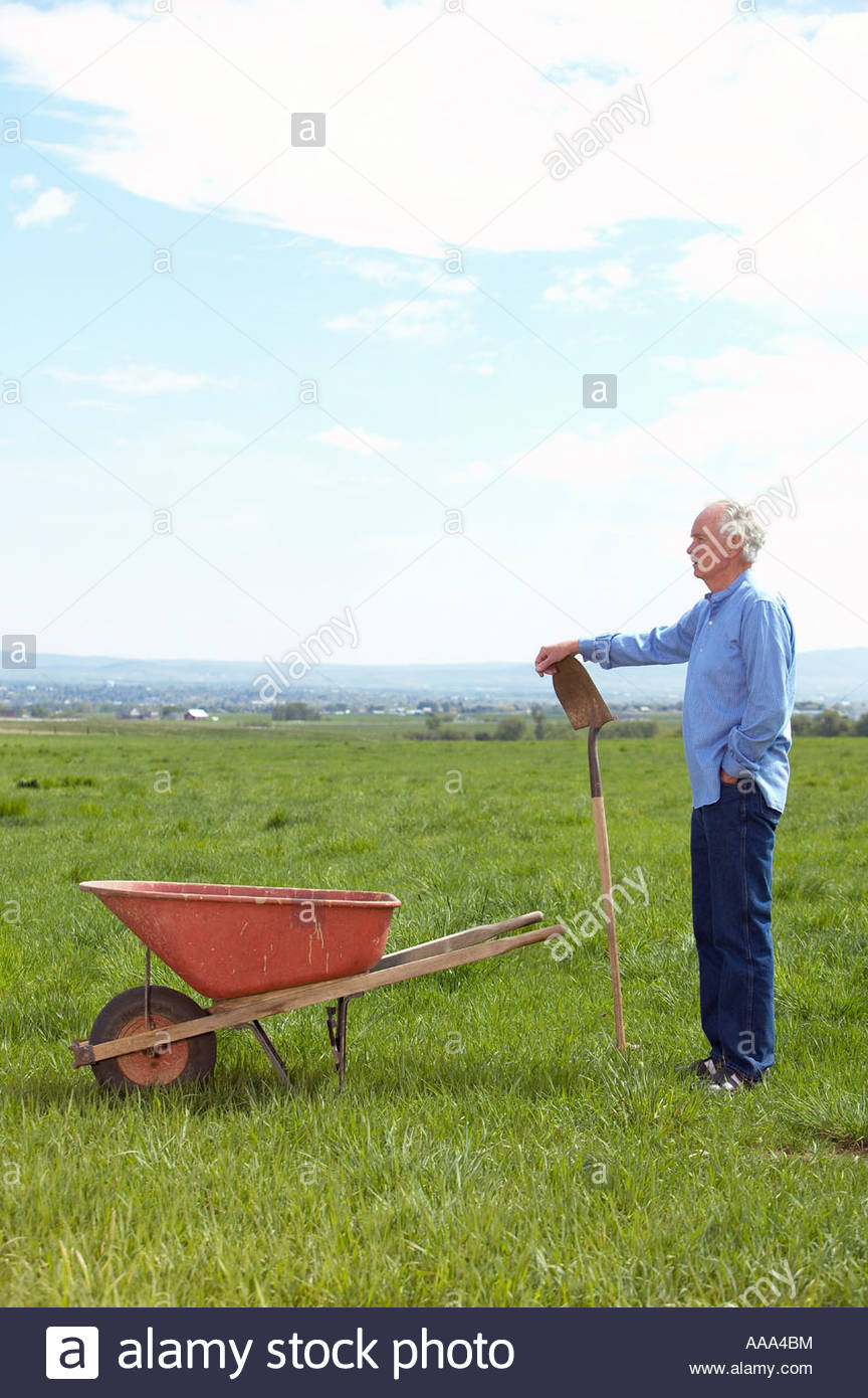 Man With Wheelbarrow Stock Photos & Man With Wheelbarrow Stock Images