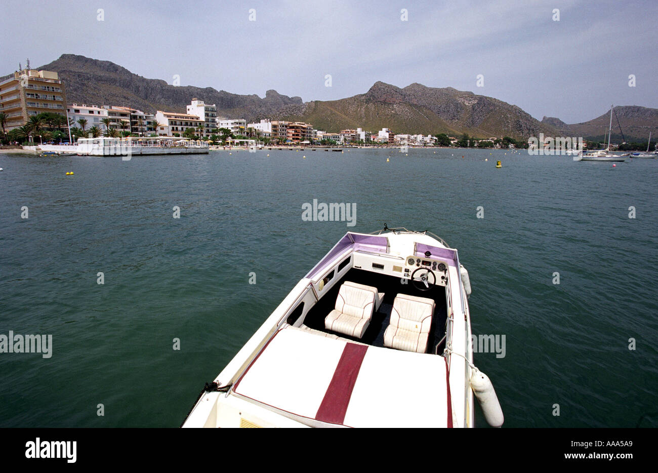 View over speedboat of Puerto Pollensa seafront and mountains in Majorca Stock Photo