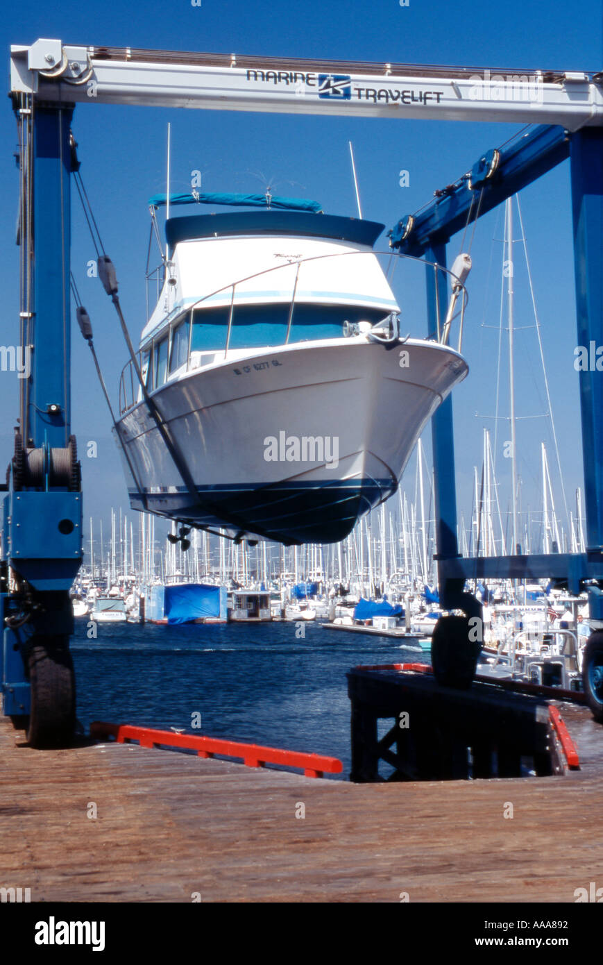 Power boat in dry dock lifted by crane Stock Photo