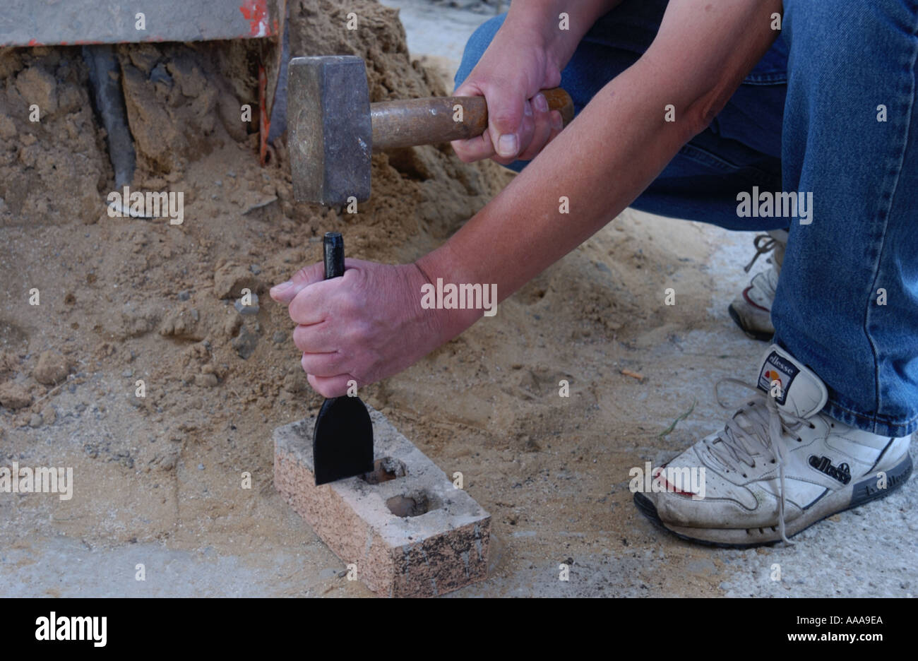 hand holding bolster chisel and hammer Stock Photo Alamy