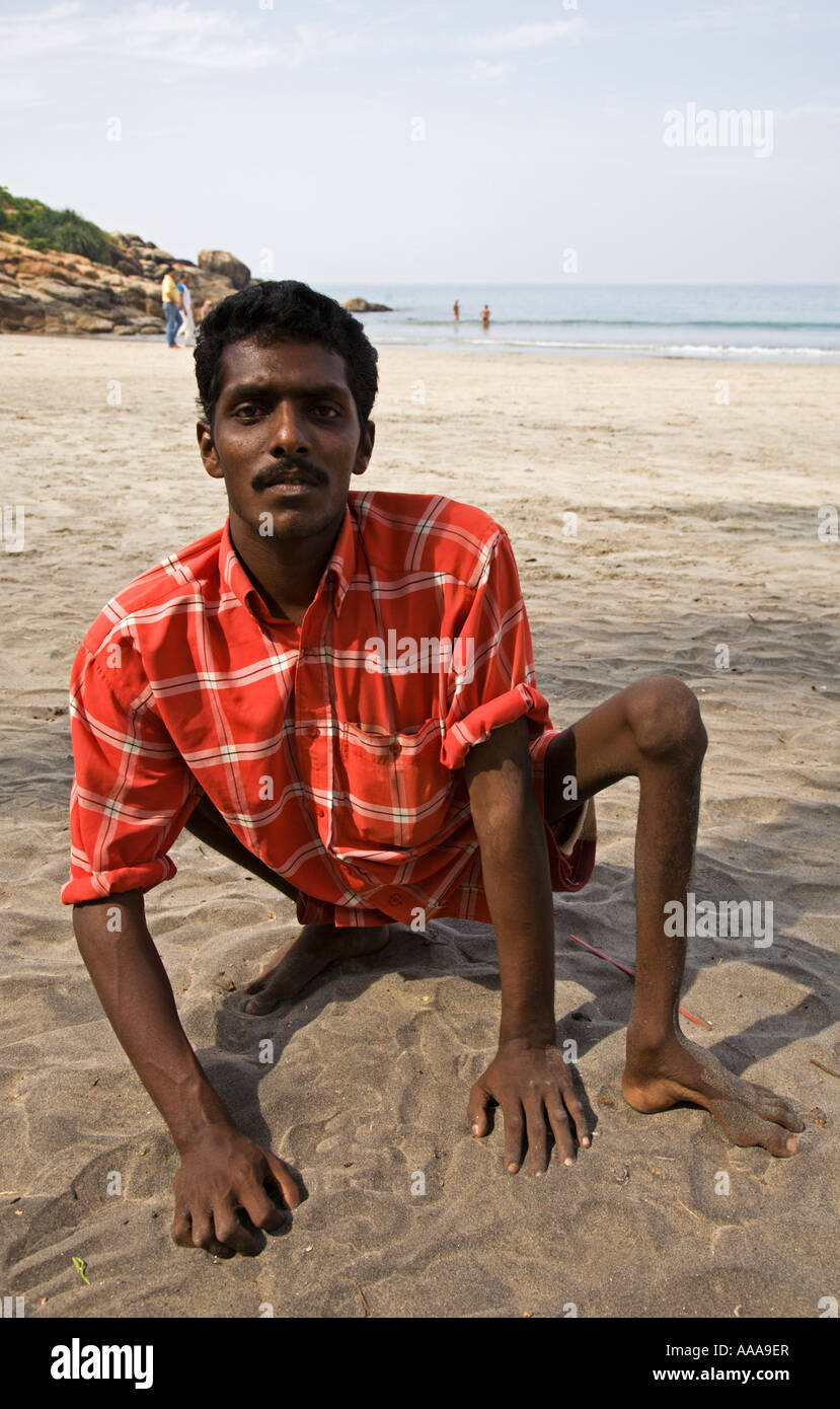 India Kerala Kovalam Handicapped young man that suffers the effects of polio. 2006 Stock Photo