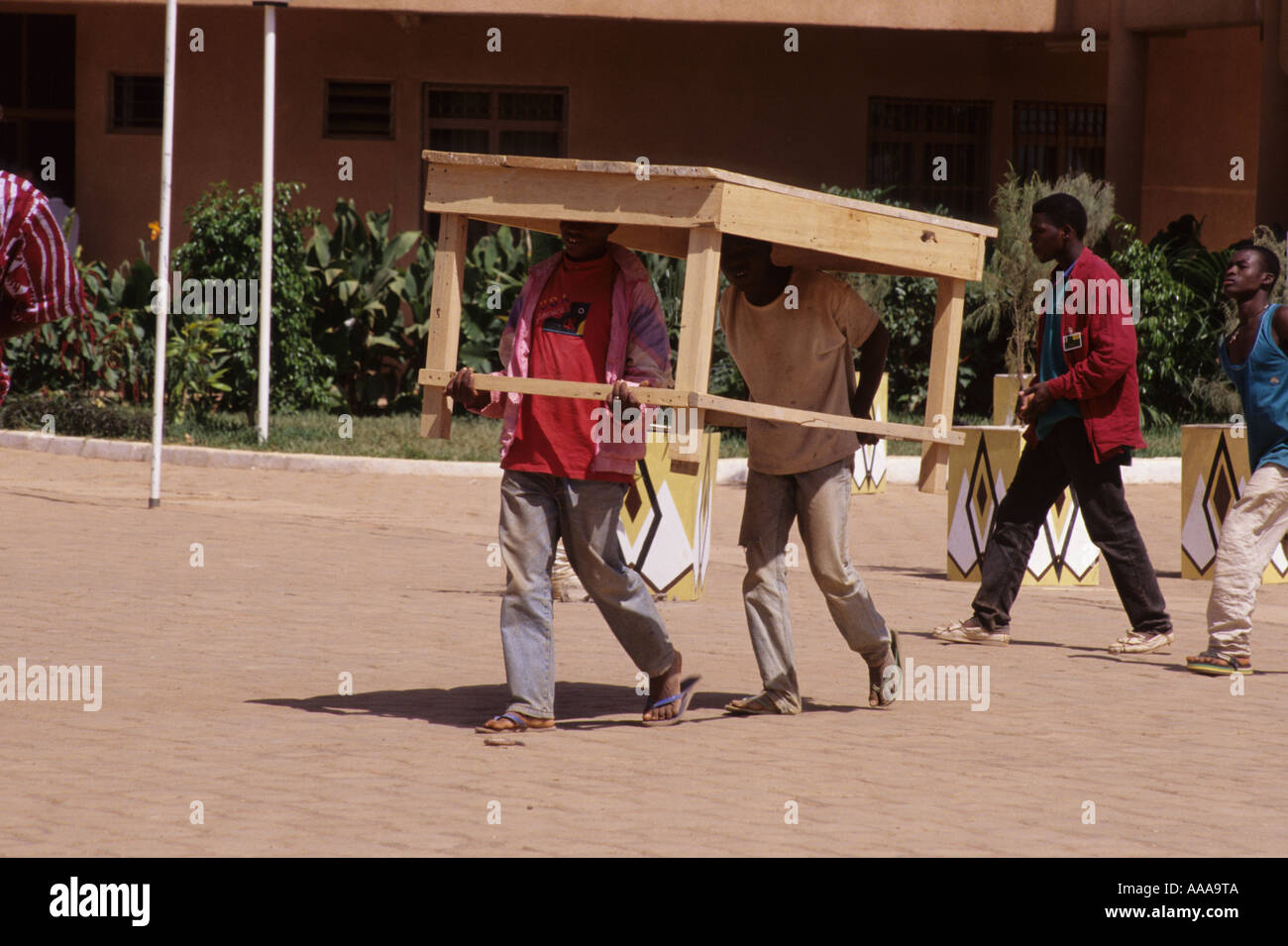 Ouagadougou, Burkina Faso, West Africa. Men Carrying Table on Heads Stock Photo
