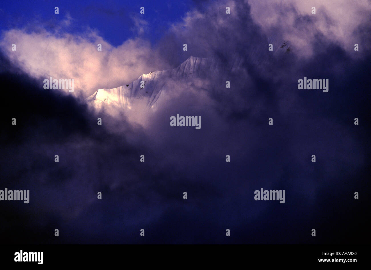 Mountain shrouded in clouds Nepal Stock Photo - Alamy
