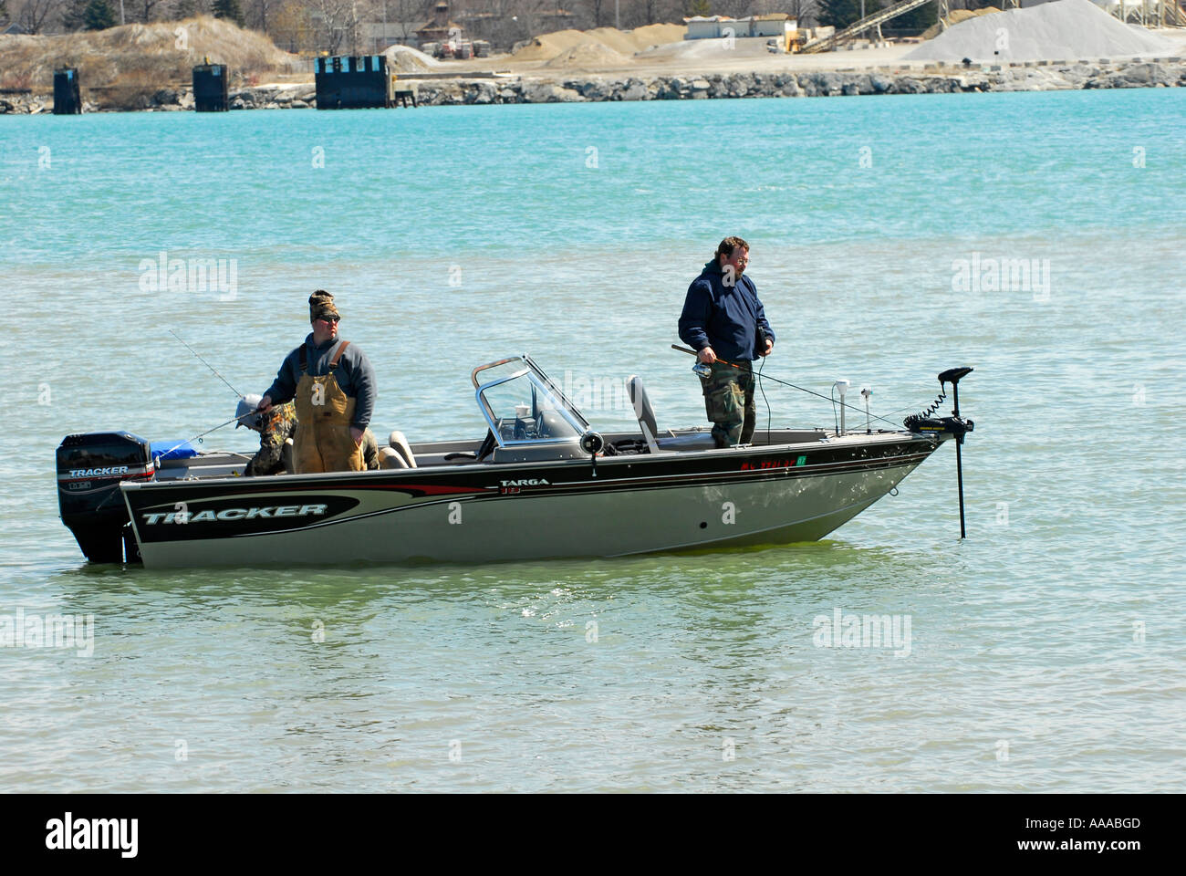 3 men fishing in the Detroit River between Lake St Clair and Lake Erie Stock Photo