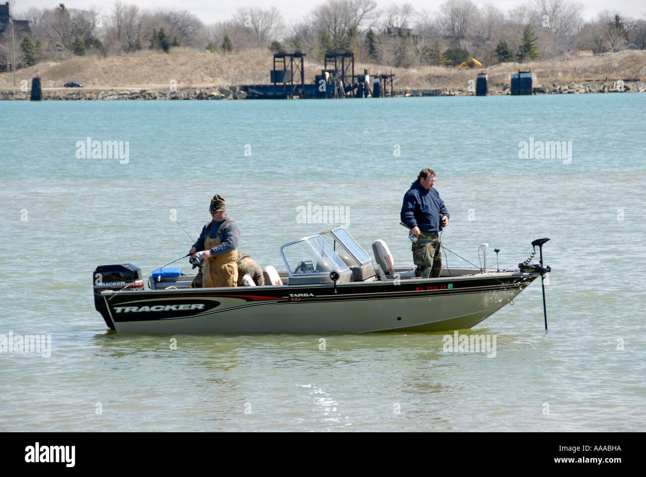 3 men fishing in the Detroit River between Lake St Clair and Lake Erie Stock Photo