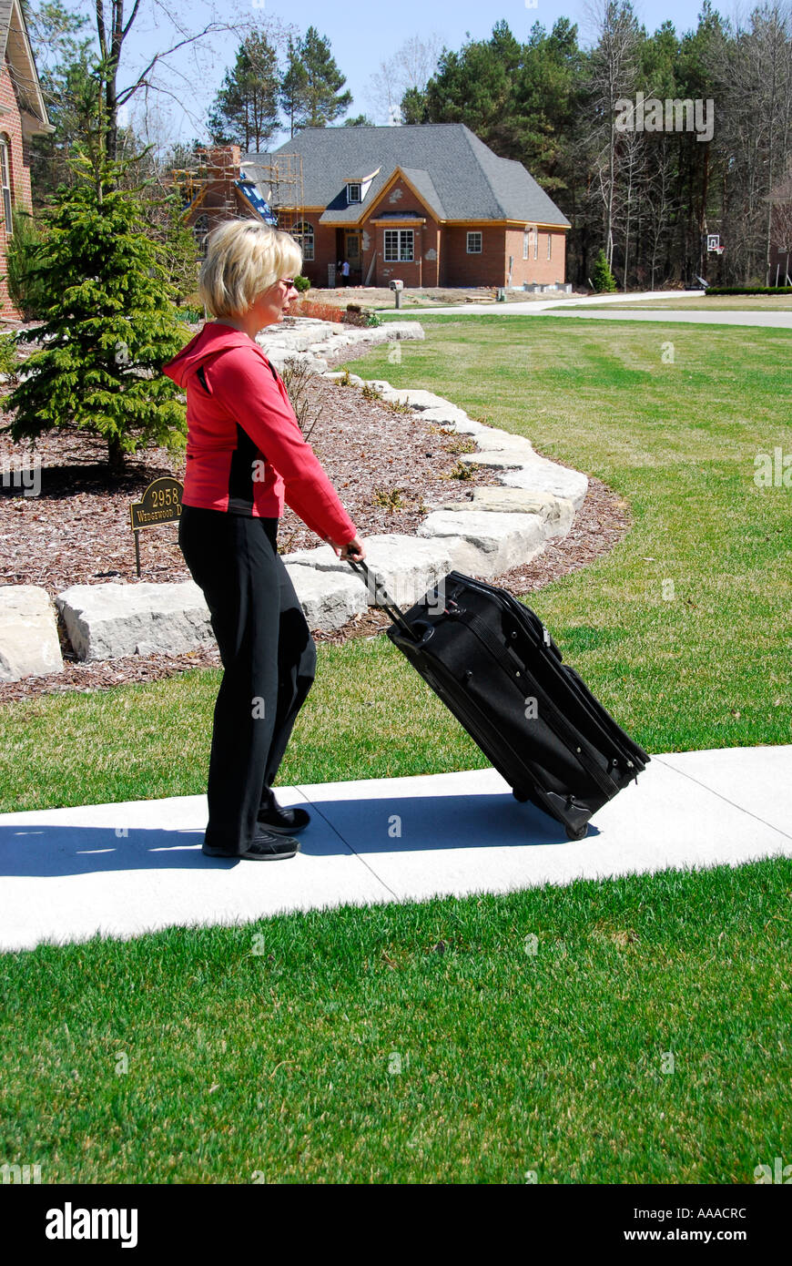 Female with suitcase Showing the concept of pulling and pushing pull
