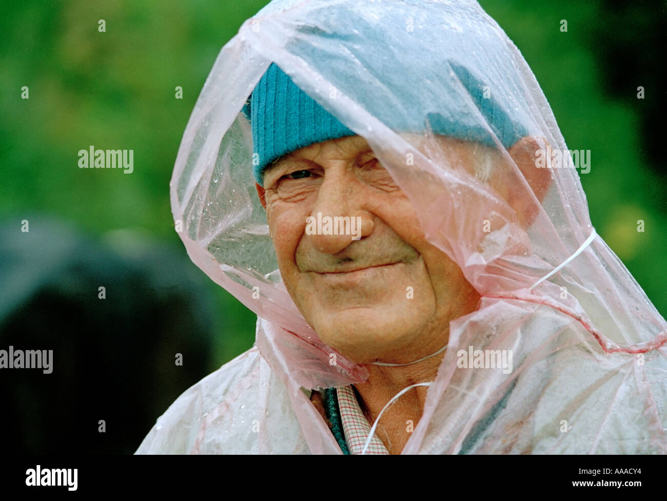 Bulgarian farmer wrapped in a plastic sheet for protection against the rain  Stock Photo - Alamy