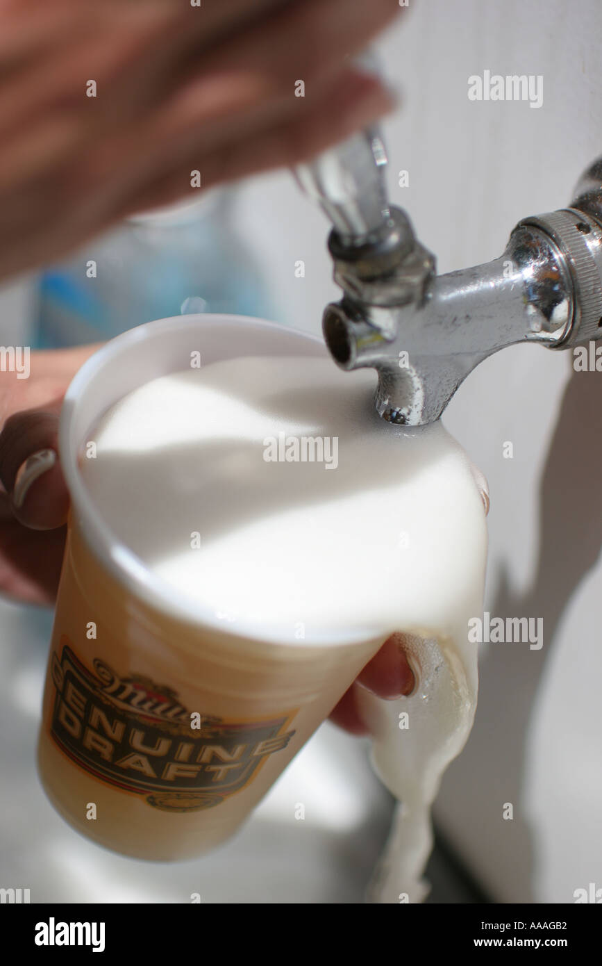 Florida, draft beer, plastic cup, dispenser, nozzle, overflow, drink foam Stock Photo Alamy