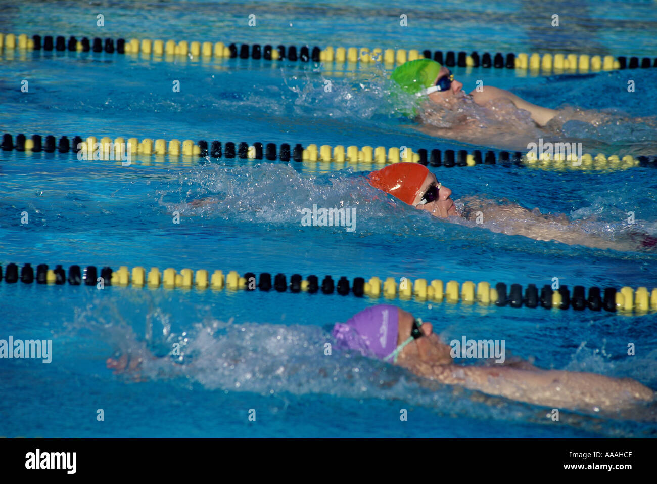 Three male swimmers in a race Stock Photo - Alamy