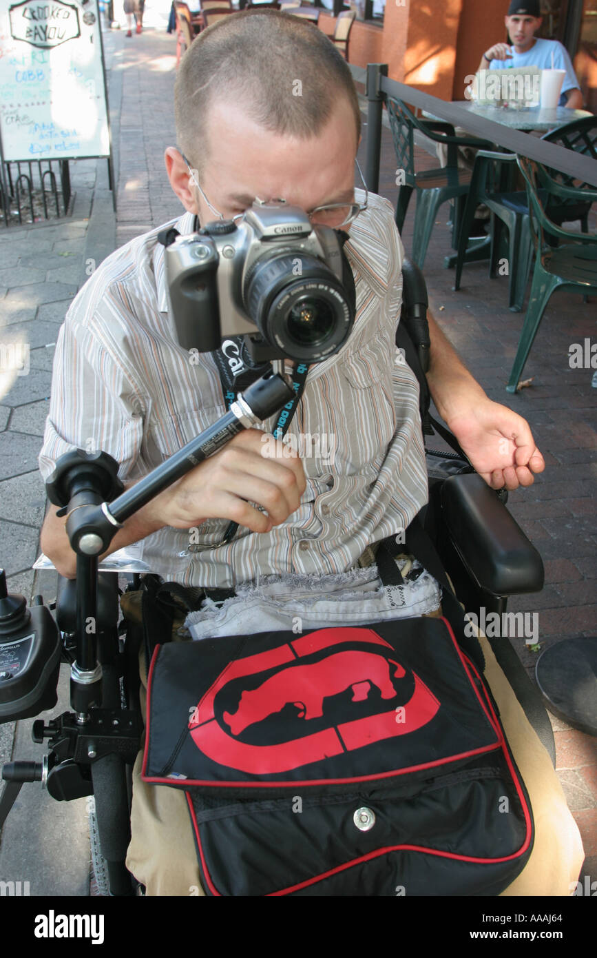 Orlando Florida,Central Avenue,disabled White man,male photographer,wheelchair,disabled disability handicapped special needs,transportation,mobility,v Stock Photo