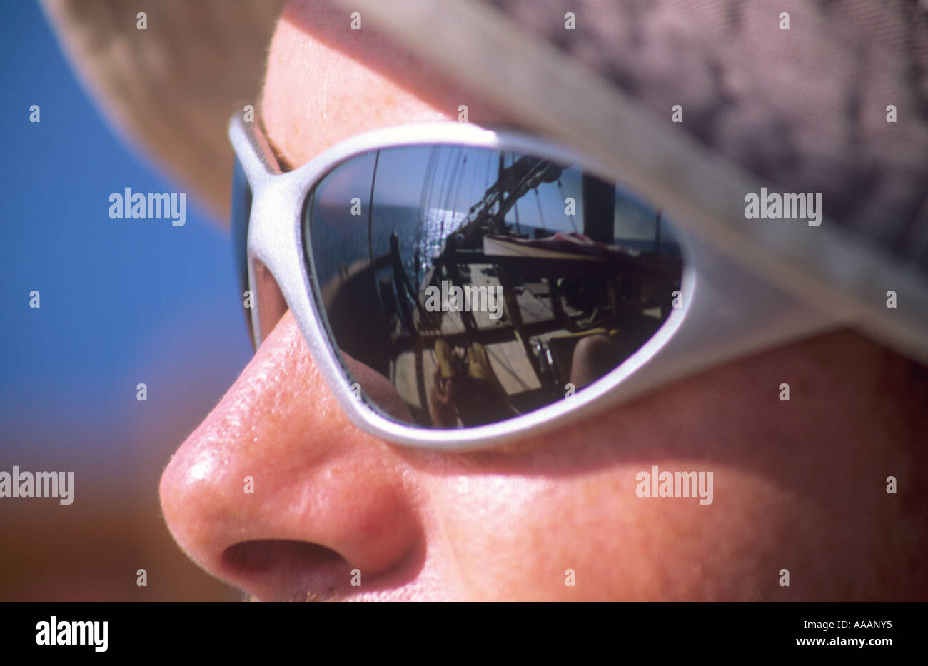 sailing scene reflected in a man's sunglasses, Oman Gulf Arabia Stock