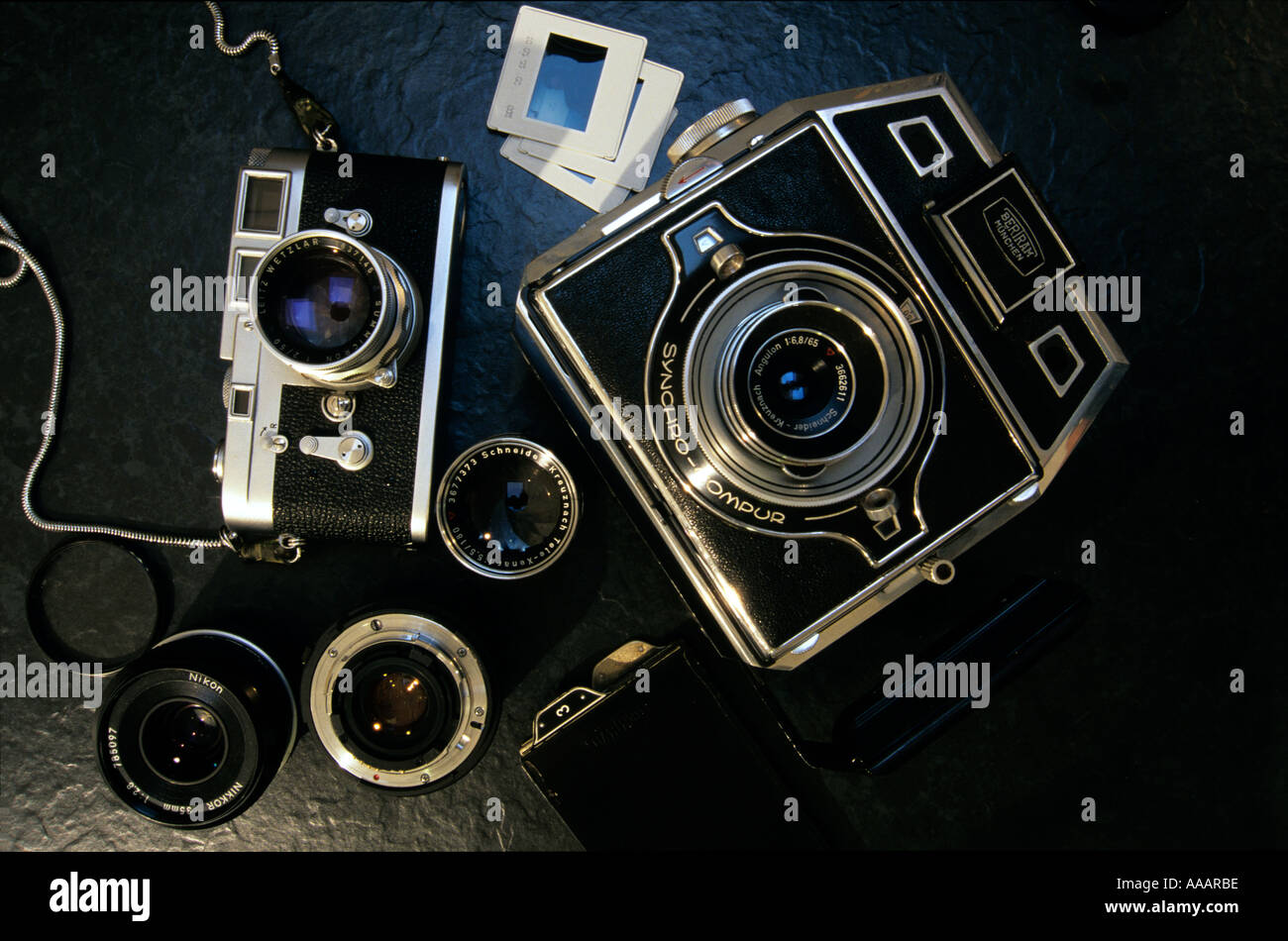 Classic German analogue cameras - a 35mm Leica M3 and a 6x9 cm Bertram press camera. Stock Photo