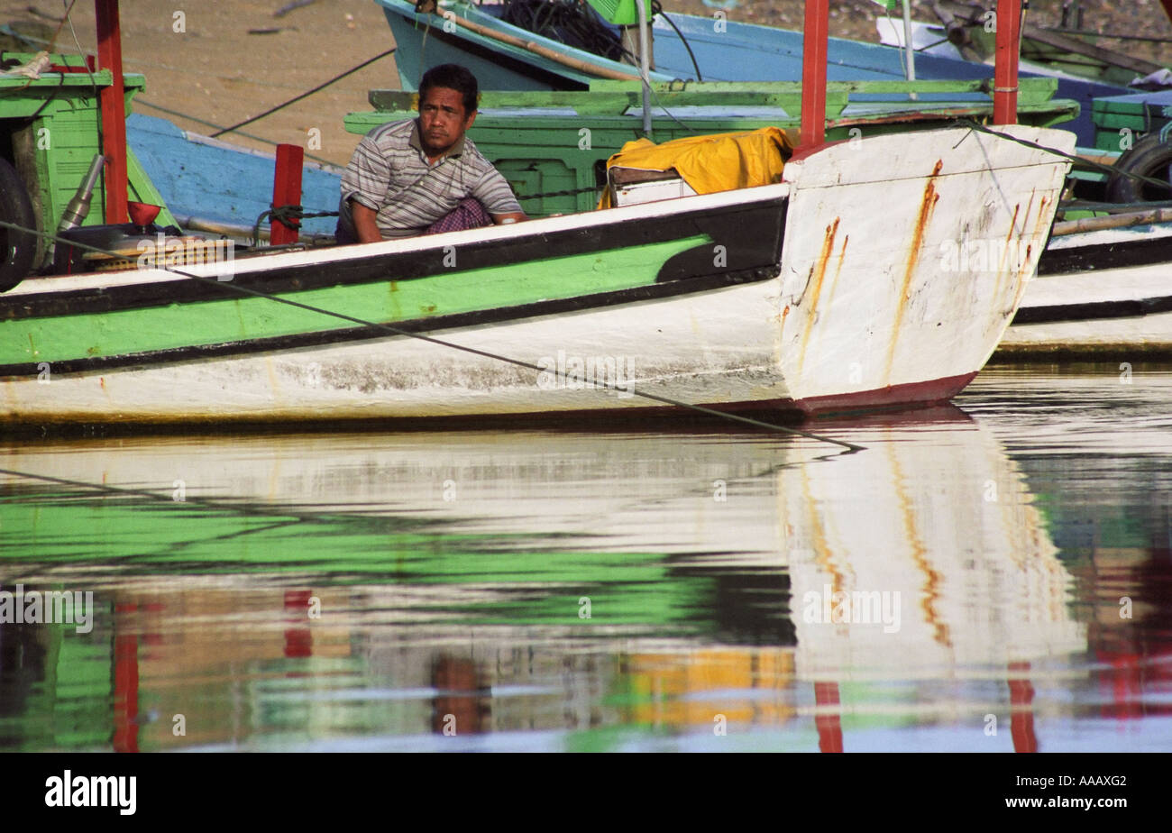 Reflection Of Man In Fishing Boat Stock Photo