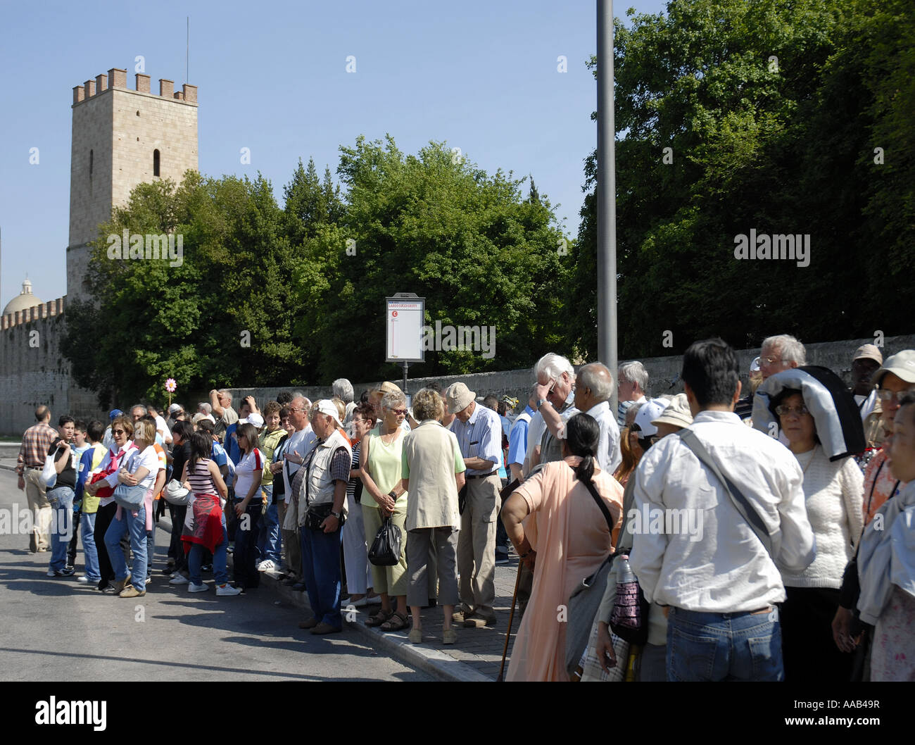 Crowds of Tourists Waiting Outside the entrance to the town of Historic Pisa Stock Photo