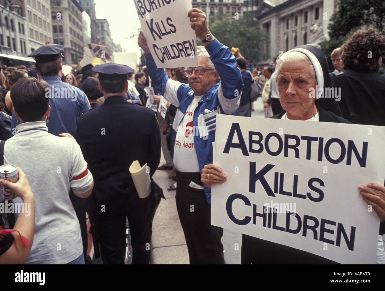 A  stand off between pro choice and pro life advocates on 5th Avenue in New York City A nun expresses her religious beliefs. Stock Photo