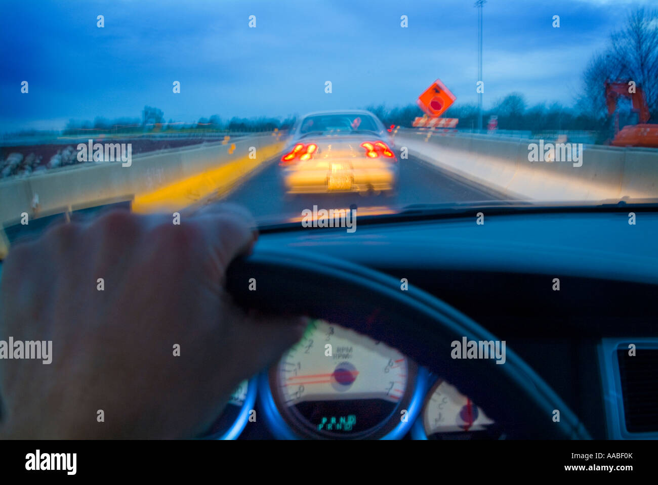 View Of Cars On Highway From Drivers Perspective With Hand On Steering Wheel, Dashboard  And Motion Blur, Philadelphia, PA USA Stock Photo