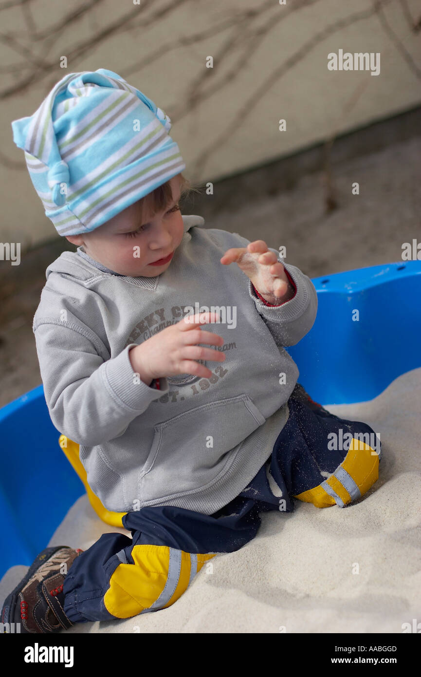 little boy playing in sand box Stock Photo - Alamy