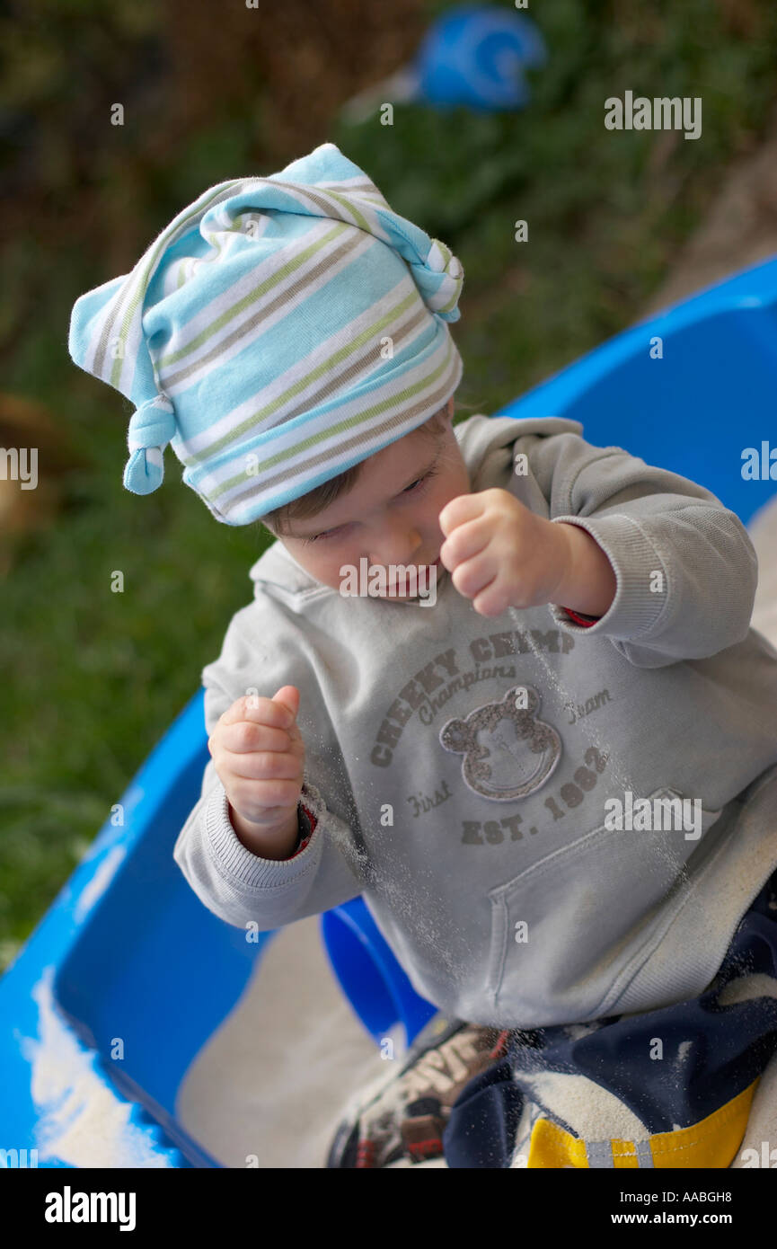little boy playing in sand box Stock Photo - Alamy
