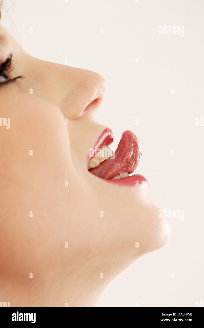 Woman sticks her tongue out Stock Photo