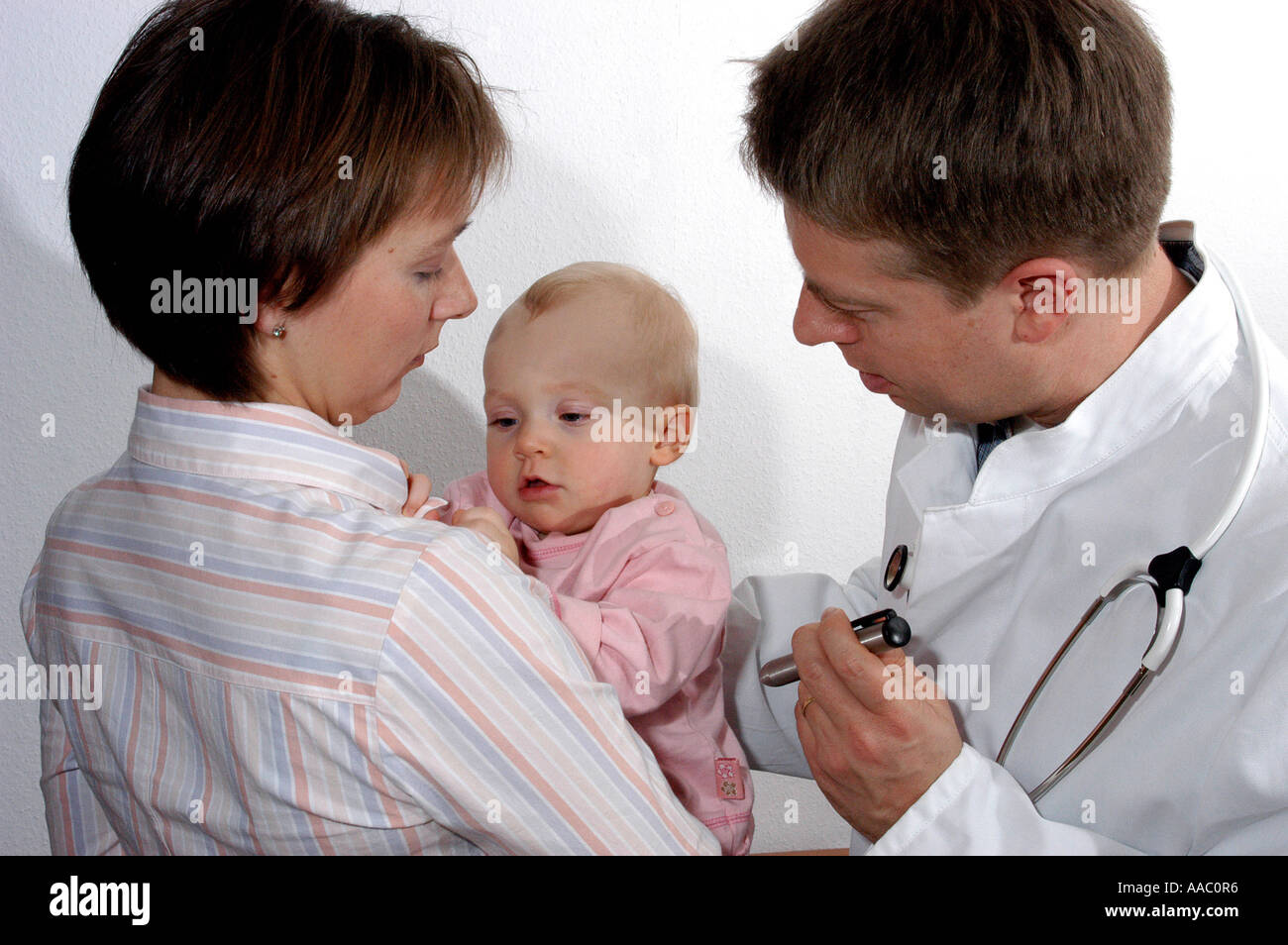 Mother and baby with the doctor Stock Photo - Alamy