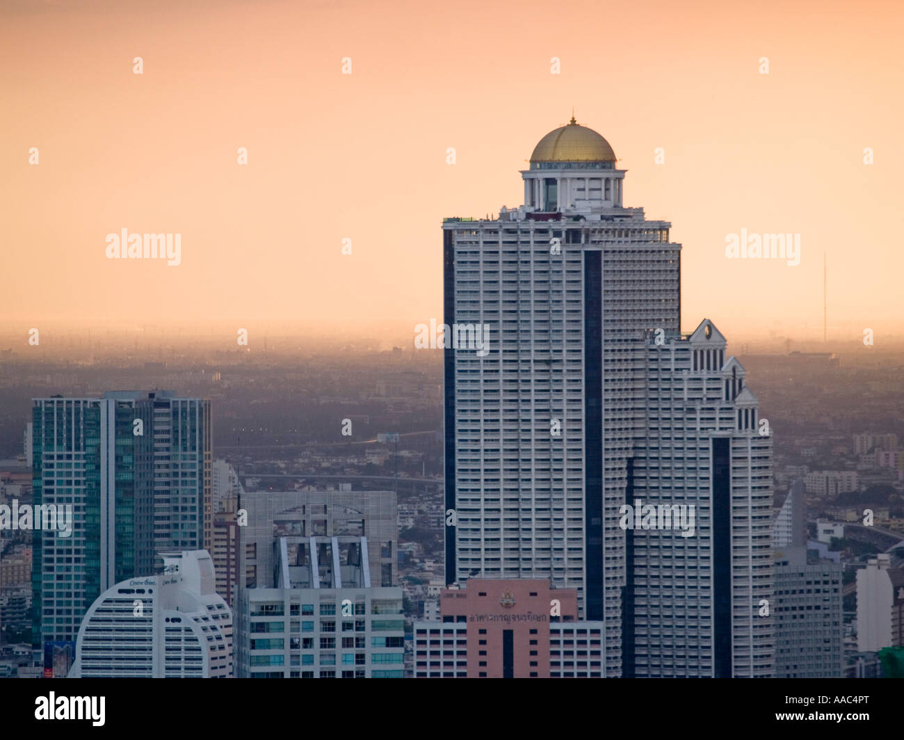 Sirocco Restaurant and Dome in the State Tower high over Bangkok s polluted sunset Stock Photo