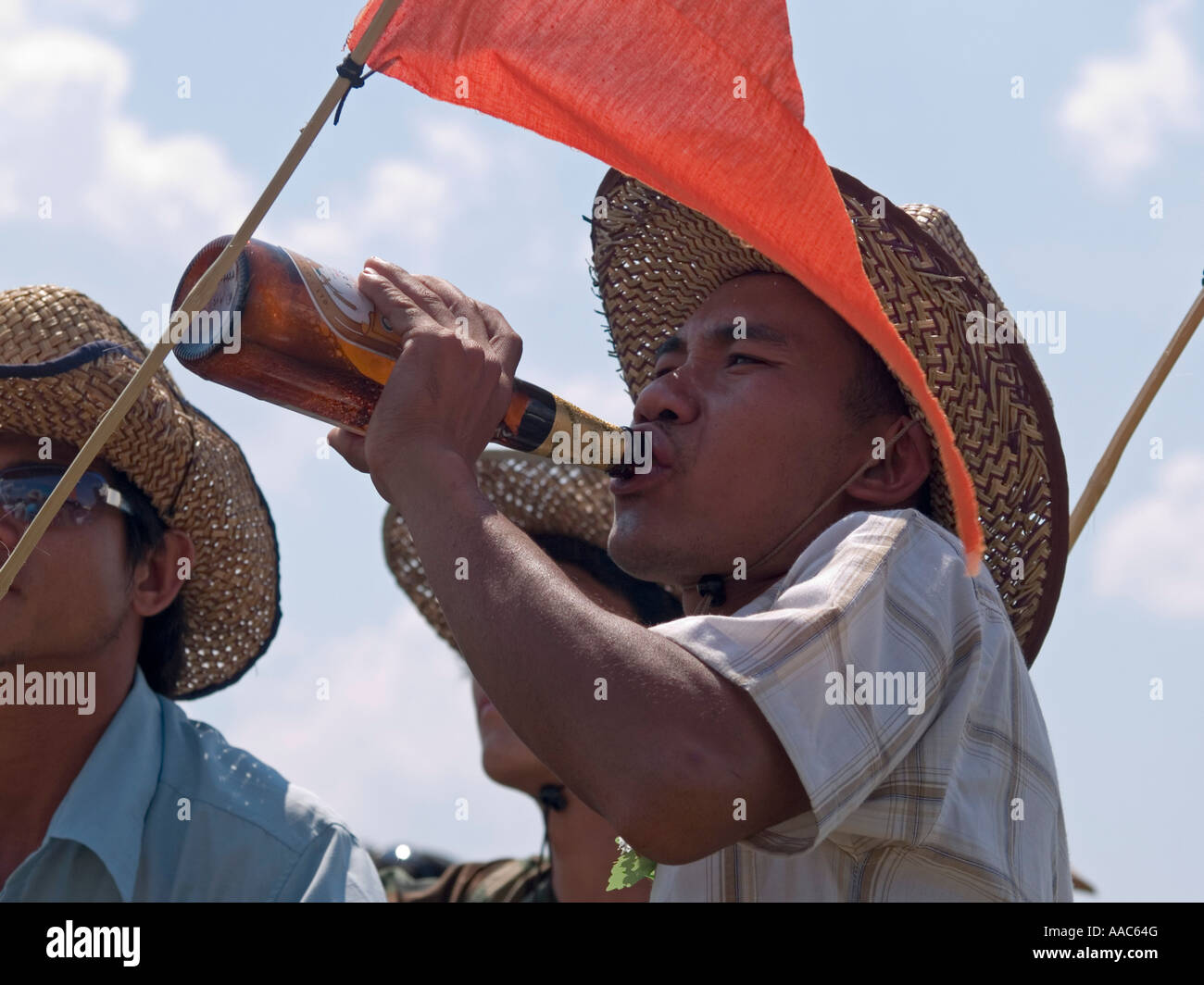 a festival goer drinks a bottle of Beer Lao celebrating the Bun Bang Fai  Rocket Festival Muang Singh Laos Stock Photo - Alamy
