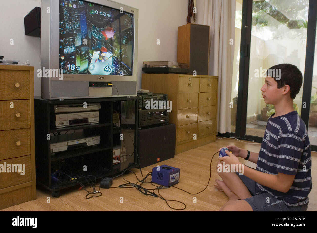 teenage boy playing Nintendo Gamecube video game Stock Photo