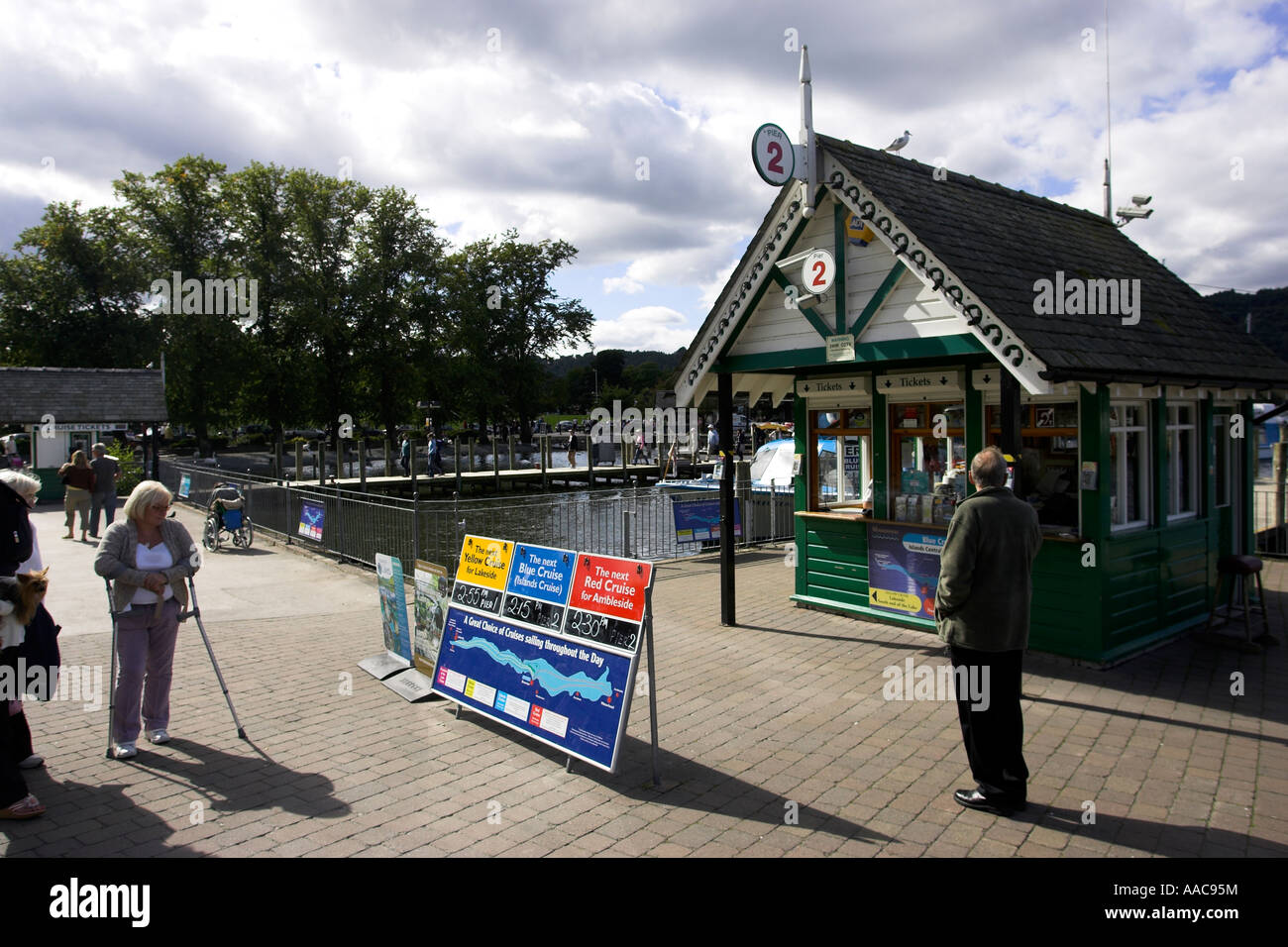 Crew updating Windermere Lake Cruises schedule timetable board on