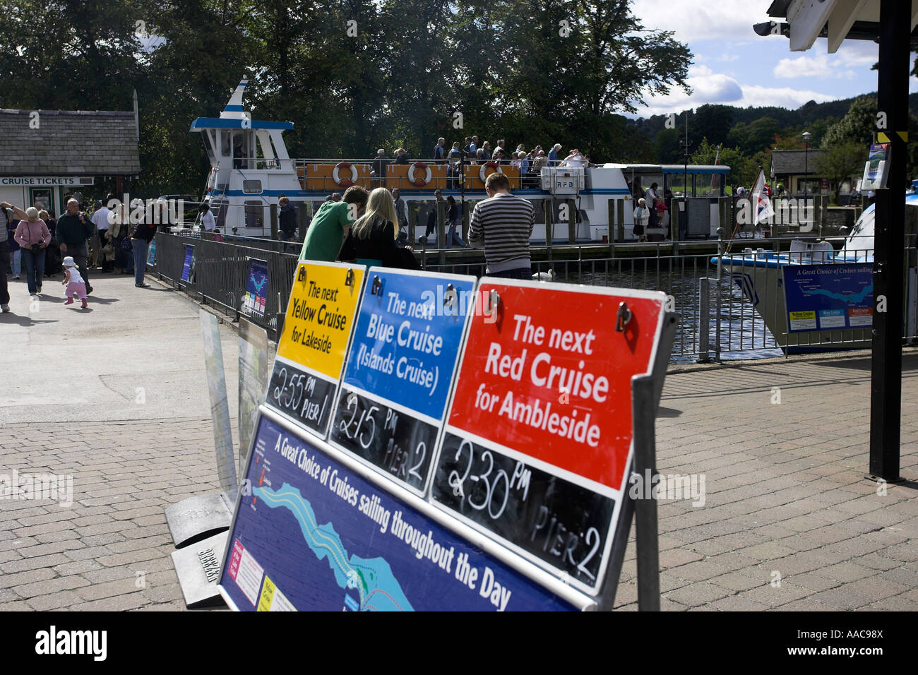 Crew updating Windermere Lake Cruises schedule timetable board on