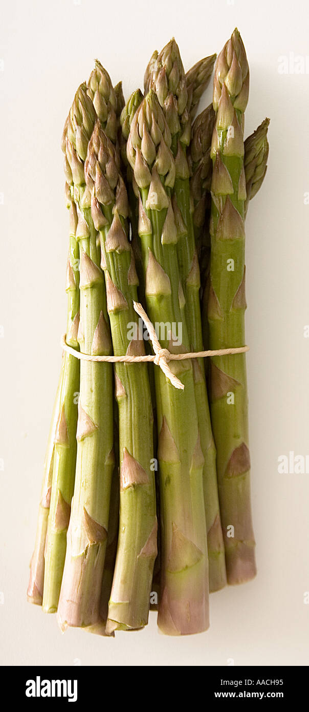 Fresh asparagus tied up with string. Shot from above on a white background ready to be cut out. Stock Photo