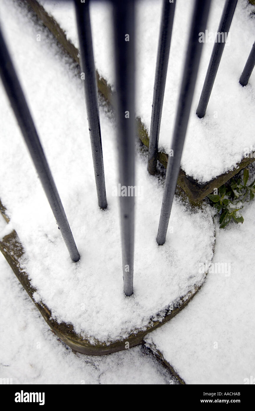 Wrought iron railings on snow-covered steps outside shop in Tunbridge Wells, Kent. Stock Photo