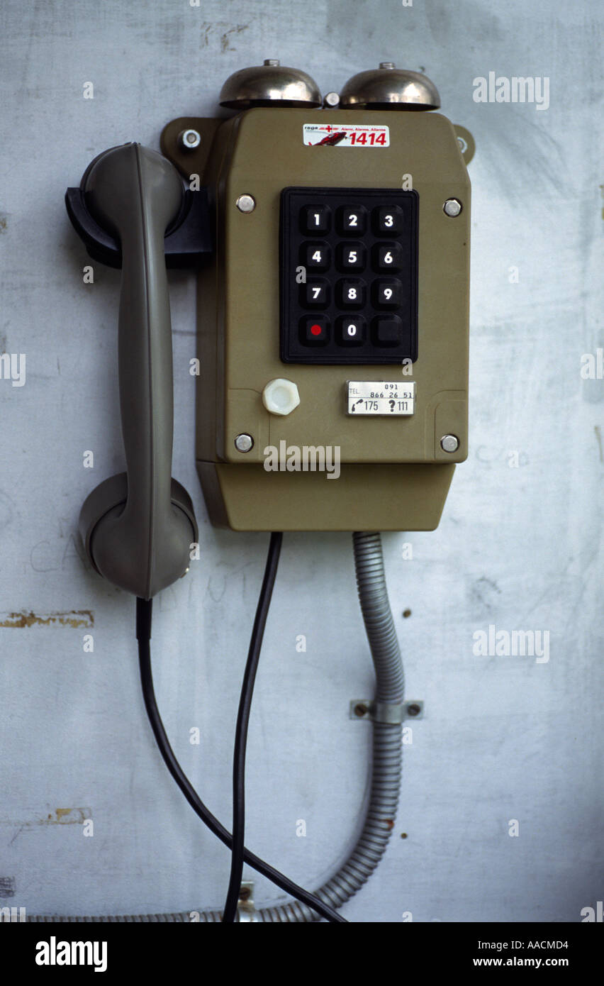 oldfashioned telephone with bells hanging on a wall Stock Photo